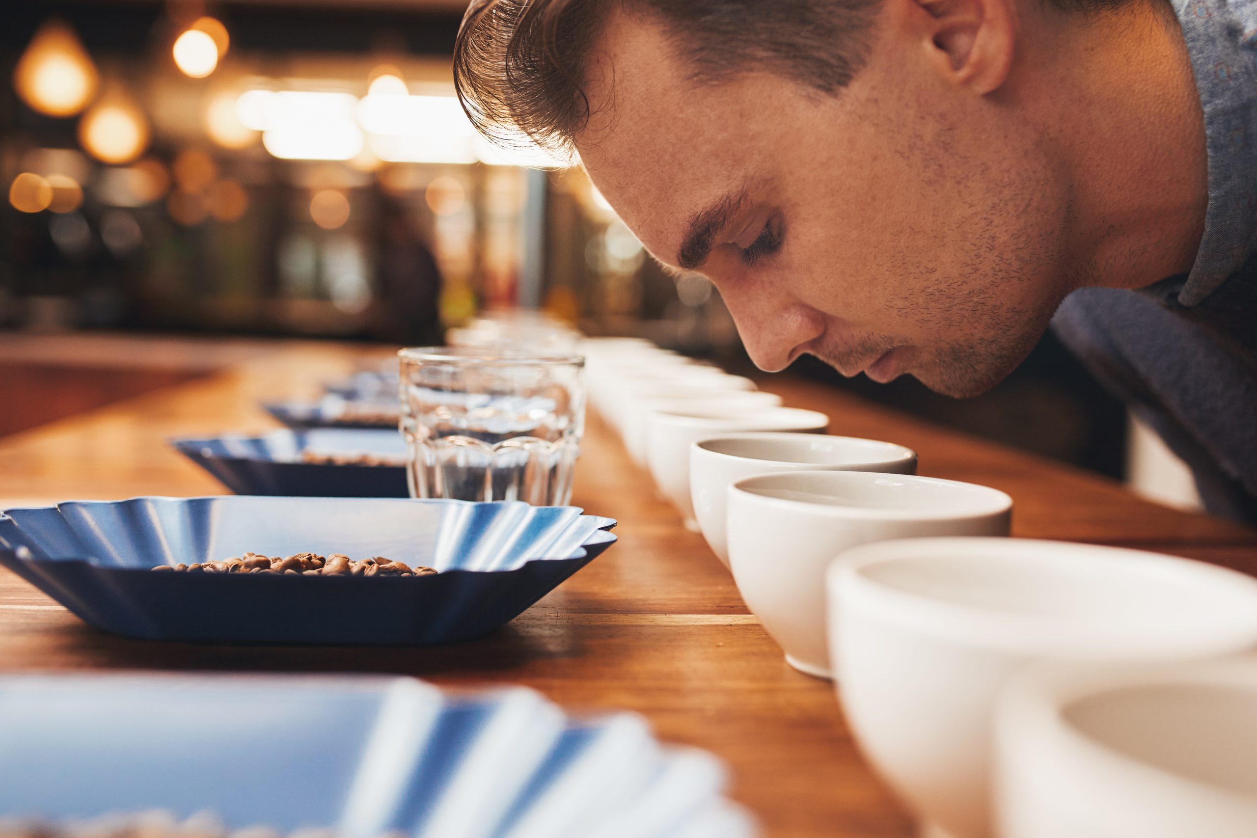 Man smelling aromatic coffee at a tasting